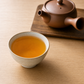 Organic Hojicha brewed amber cup with kyusu teapot